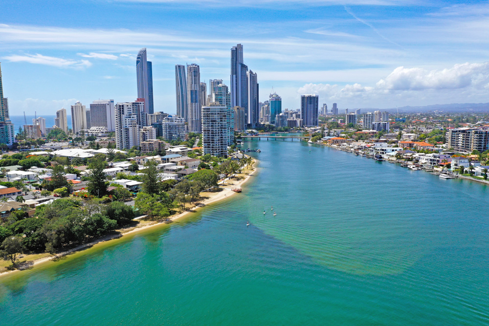 Surfers Paradise skyline and River with 4 Stand Up Paddle Boarders