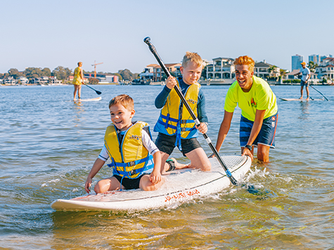 Kids on a stand up paddle board in Surfers Paradise